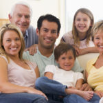 Extended family in living room smiling